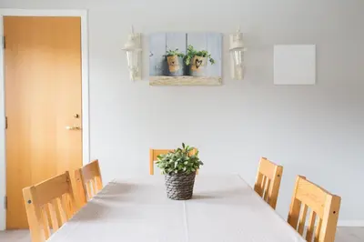 a dining room table with a potted plant on it at Sauda Fjord Camping in Saudasjøen