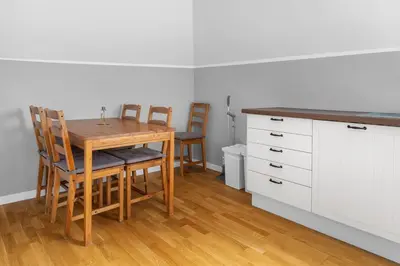 a kitchen with a table and chairs and a counter at Experience Norway's History I With Free Parking in Bergen