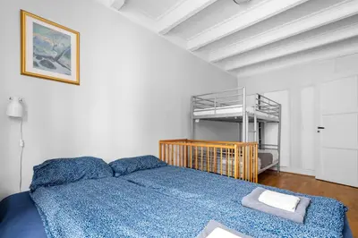 a bedroom with a bed and a bunk bed at Experience Norway's History I With Free Parking in Bergen