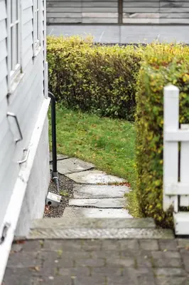 a stone walkway next to a house with a window at Experience Norway's History I With Free Parking in Bergen