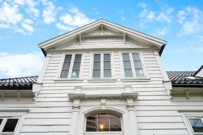 a white building with windows on top of it at Experience Norway's History I With Free Parking in Bergen