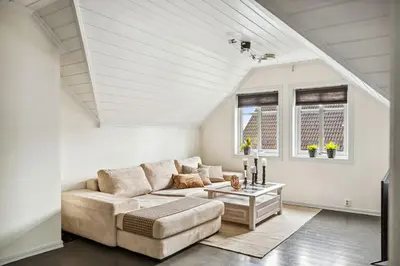 a living room with a couch and a table at Sentral enebolig til utleie under Ski VM 2025 in Trondheim