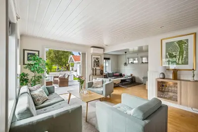 a living room with two couches and a table at Sentral enebolig til utleie under Ski VM 2025 in Trondheim