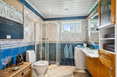 a bathroom with a toilet and a sink at Sentral enebolig til utleie under Ski VM 2025 in Trondheim