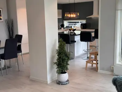 a kitchen and living room with a potted plant at Enebolig Trondheim syd in Trondheim