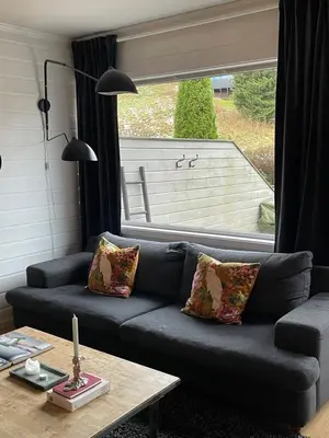 a living room with a couch and a table at Rekkehus til leie for ski-VM 2025! I nærheten av VM-arenaen! in Trondheim