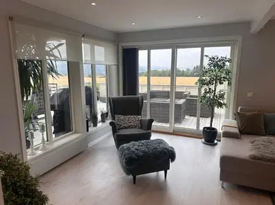 a living room with a couch and a chair at Stor enebolig Trondheim syd in Trondheim