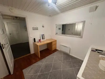 a room with a desk and a mirror and a door at Stor enebolig Trondheim syd in Trondheim