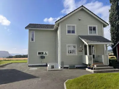 a large house with a driveway in front of it at Stor enebolig Trondheim syd in Trondheim