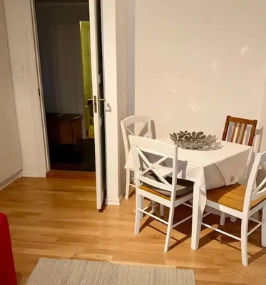 a white table and chairs in a living room at Panoramic Fjord View near Bergen in Bergen