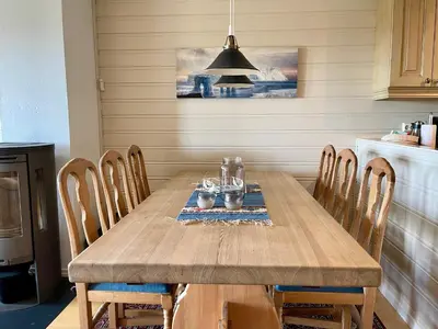 a dining room with a wooden table and chairs at Spacious Stay With 3 Bedrooms And 2 Baths in Beitostøl