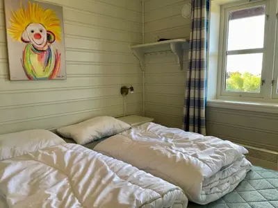a room with two beds in it with a window at Spacious Stay With 3 Bedrooms And 2 Baths in Beitostøl
