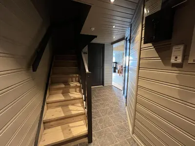 a staircase in a house with wooden walls and wooden floors at Large Balcony With Panoramic Mountain Views in Beitostøl