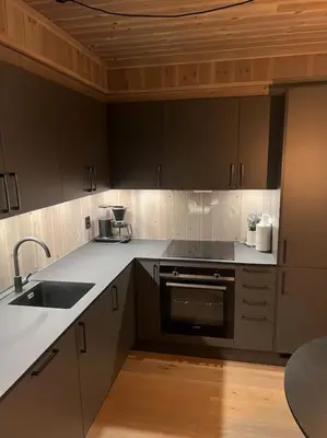 a kitchen with a sink and a stove top oven at Helt ny leilighet ski in- ski out i Hemsedal in Hemsedal