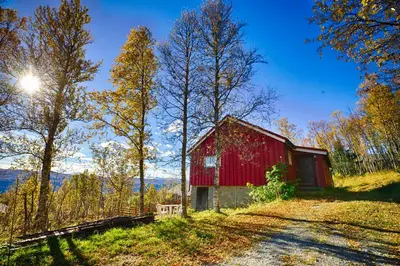 a red barn sitting on top of a hill at Charming Cabin Ski-In Access And Pet Friendly in Beitostøl