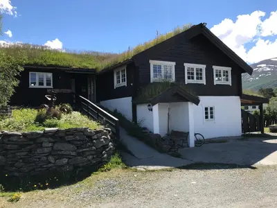 a black and white house with a grass roof at Granmo Camping in Oppdal