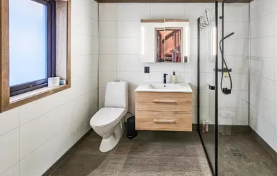a bathroom with a toilet and a sink and a shower at Stunning Home In Vinje With Wifi in Trovatn