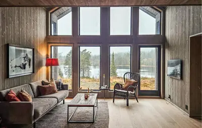 a living room with a couch and large windows at Stunning Home In Vinje With Wifi in Trovatn