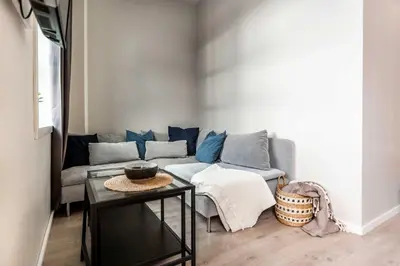 a living room with a couch and a table at Beautiful Harbour Apartment With French Balcony in Bergen