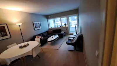 a living room with a couch and a table at Ski in ski out 2bdr apartment in Trondheim