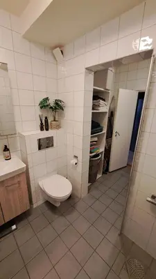 a bathroom with a toilet and a sink at Ski in ski out 2bdr apartment in Trondheim