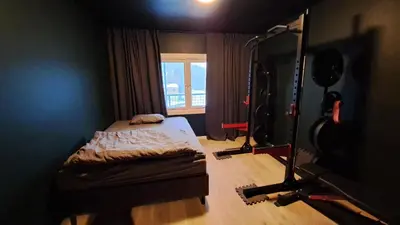 a small room with a bed and a window at Ski in ski out 2bdr apartment in Trondheim