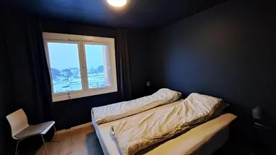 a bedroom with two beds and a window at Ski in ski out 2bdr apartment in Trondheim