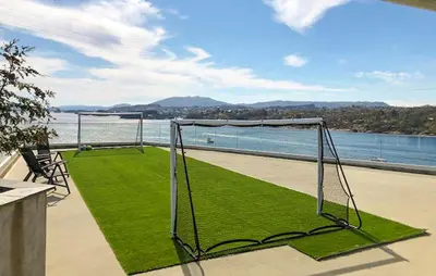 a goal on a balcony with a view of the water at Gorgeous Apartment With Wifi in Godvik