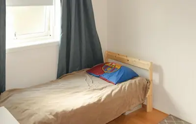 a small bed in a room with a window at Gorgeous Apartment With Wifi in Godvik