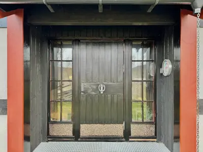 a front door of a house with two windows at Spacious cabin with beautiful Geilo views in Geilo