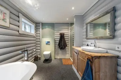 a bathroom with a sink and a toilet and a mirror at Hemsedal Mountain Retreat in Hemsedal
