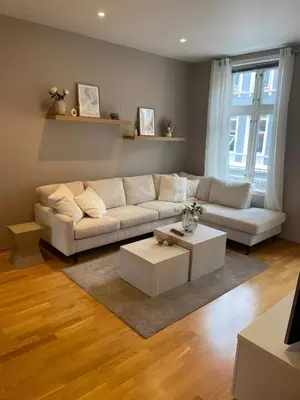 a living room with a couch and a coffee table at Lovely 3-room gem in the heart of Bergen City in Bergen