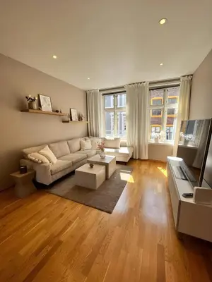 a living room with a couch and a table at Lovely 3-room gem in the heart of Bergen City in Bergen