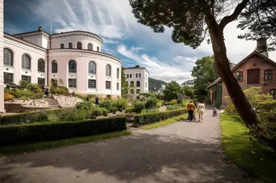 a family walking down a path in front of a building at Lovely 3-room gem in the heart of Bergen City in Bergen