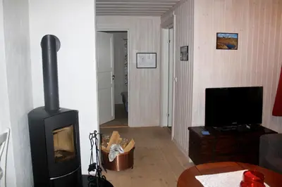 a living room with a fireplace and a television at Apartment By Cross-Country And Alpine Slopes in Beitostøl