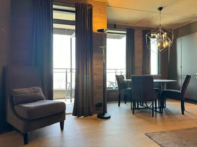 a living room with a table and chairs and a dining room at Riddertunets stilfulle in Beitostøl