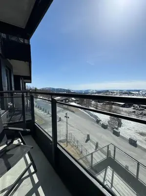 a balcony of a building with a view of the ocean at Riddertunets hygge in Beitostøl