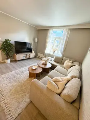 a living room with a couch and a tv at Sentral og koselig leilighet i Trondheim in Trondheim