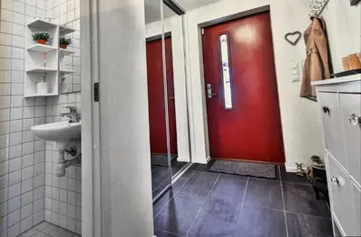 a bathroom with a red door and a sink at Skyttarbakken 57 in Heimdal