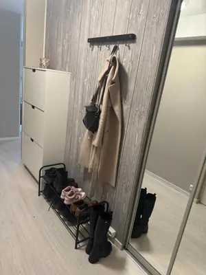 a mirror in a dressing room with boots and coats at Leilighet nært Granåsen skisenter in Trondheim