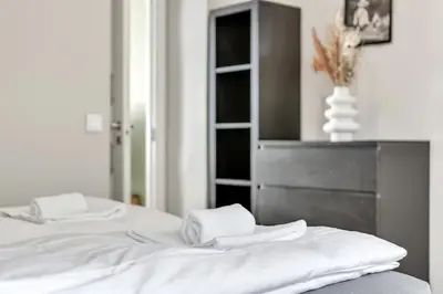 two white towels sitting on top of a bed at City Retreat in Bergen