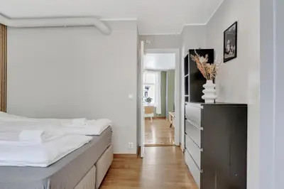 a bedroom with a bed and a dresser and a hallway at City Retreat in Bergen
