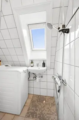 a bathroom with a sink and a window at City center apartment with teracce in Bergen