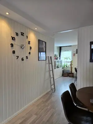 a room with a wall clock on a wall at Exclusive three-story villa near the ski center in Trondheim
