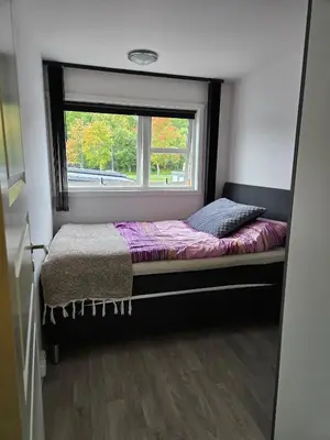 a bed in a room with a window at Exclusive three-story villa near the ski center in Trondheim