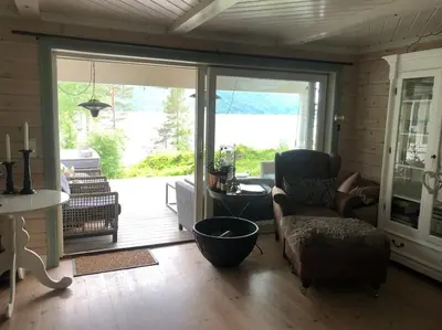 a living room with a large sliding glass door at PARADISET - a beautiful pearl 1,45 minutes from Trondheim in Surnadal