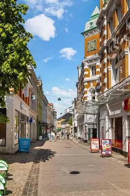 a city street with a clock tower on a building at Dinbnb Apartments l Free Parking l 5 Min From Torget l Nearby Coast I Newly Furnished in Bergen
