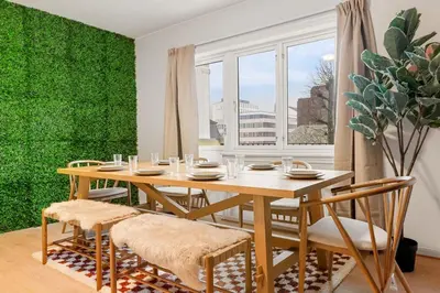 a dining room with a wooden table and chairs at Dinbnb Apartments l Free Parking l 5 Min From Torget l Nearby Coast I Newly Furnished in Bergen