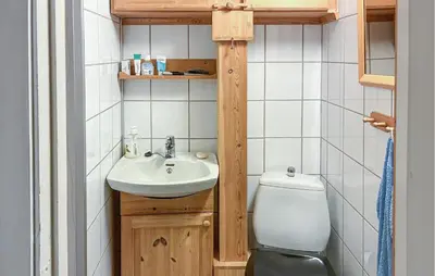 a small bathroom with a sink and a toilet at Lovely Home In Lena With Wifi