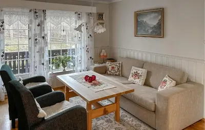 a living room with a couch and a table at Lovely Home In Lena With Wifi